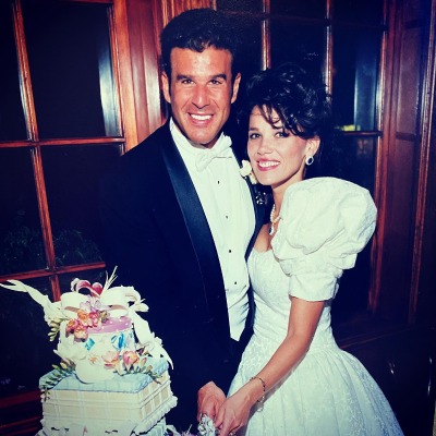 Cheri Steinfeld and her husband, Peter Steinfeld, cutting their wedding cake.